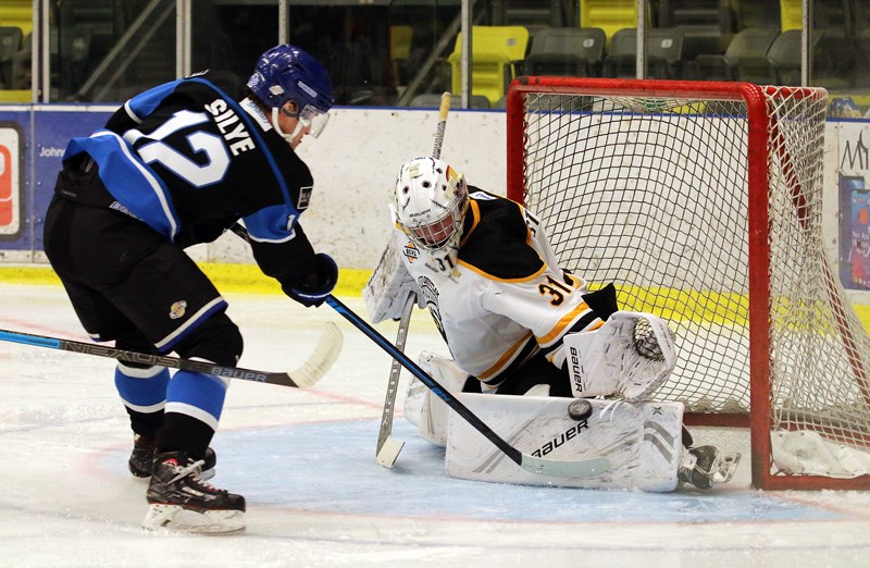 Coquitlam Express goalie Clay Stevenson stops Penticton Vees forward David Silye in tight in the second period of their BC Hockey League game, Wednesday at the Poirier Sport and Leisure Complex.