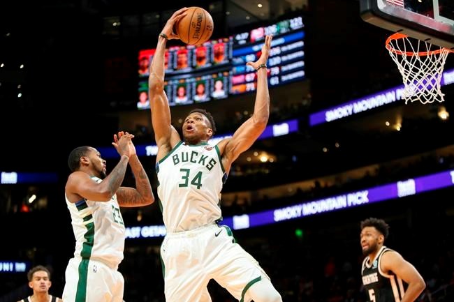 Milwaukee Bucks forward Giannis Antetokounmpo (34) grabs a rebound against the Atlanta Hawks in the second half of an NBA basketball game, Wednesday, Nov. 20, 2019, in Atlanta. (AP Photo/Brett Davis)