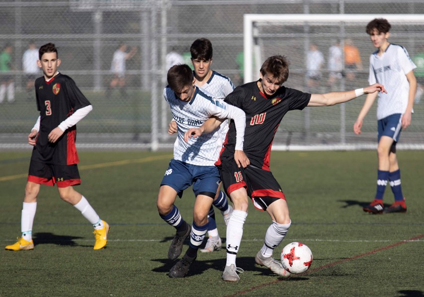 STA's Lucas Borejszo (No. 10 in black) battles for the ball during the senior boys provincial AA soccer final against Notre Dame Wednesday at Burnaby Lake Sports Complex. photo supplied STA Athletics