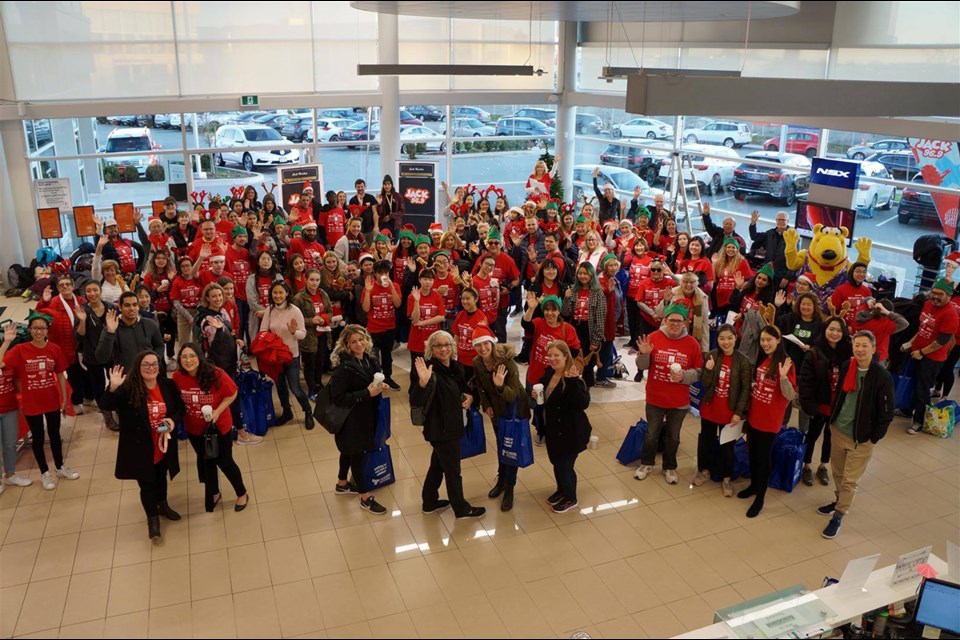 Volunteers and sponsors gathered at the Richmond Auto Mall on Nov. 20 for their annual Windows of Hope fundraiser. Photo submitted