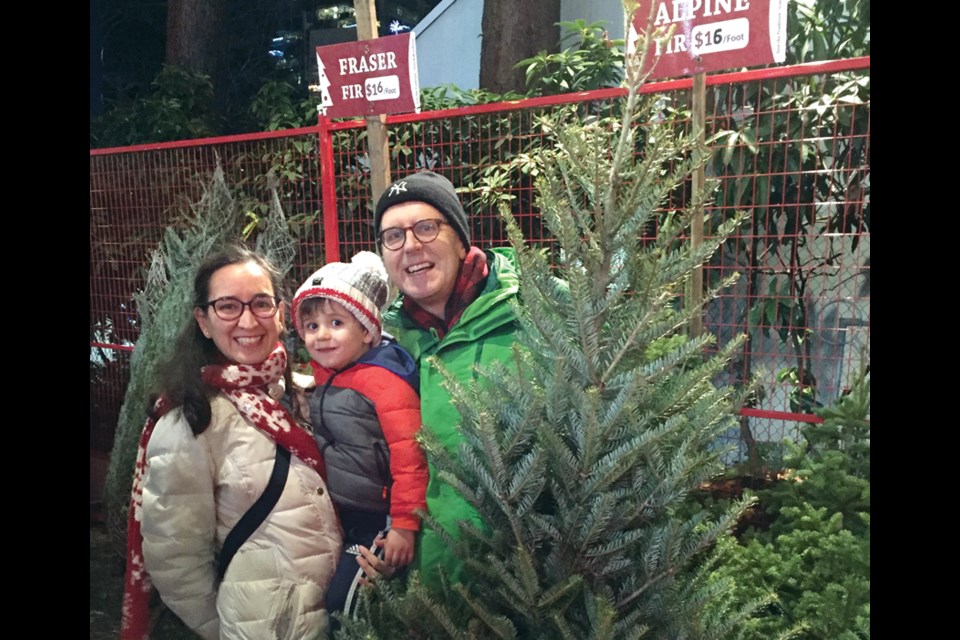 Lourdes Perez de Lara and her husband Graeme Conlon are joined by their son Martin in the Aunt Leah's Christmas tree lot at Lonsdale Quay. photo supplied