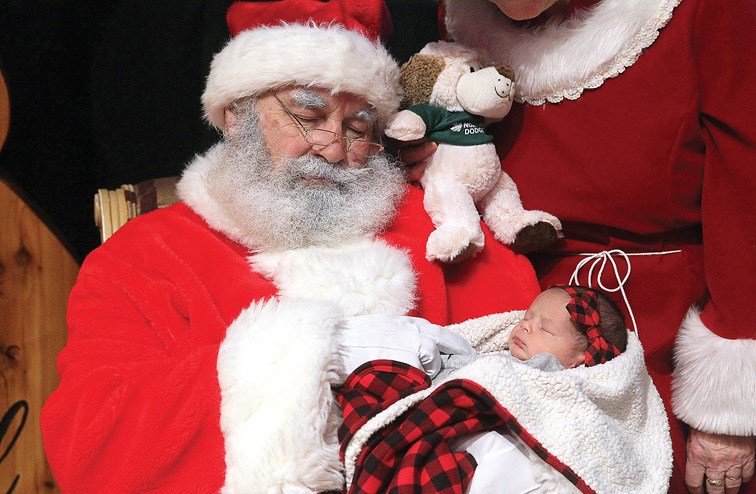 Citizen Photo by James Doyle. Santa Claus pretends to nap with a sleeping two-week-old McKenna Lynn Paziuk on Sunday morning at Prince George Civic Centre during the Santa Breakfast at the 26th Annual Festival of Trees.