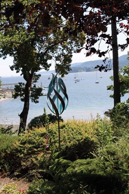 A view of the marina and Ganges' city centre can be seen from Hastings House Country House Hotel on Salt Spring Island while sheep roam the surrounding fields and sculptures adorn the landscape.