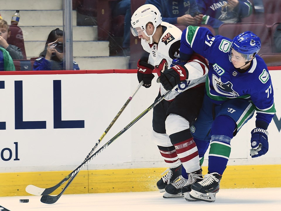 Nikolay Goldobin battles for a puck in the Canucks 2019 preseason.