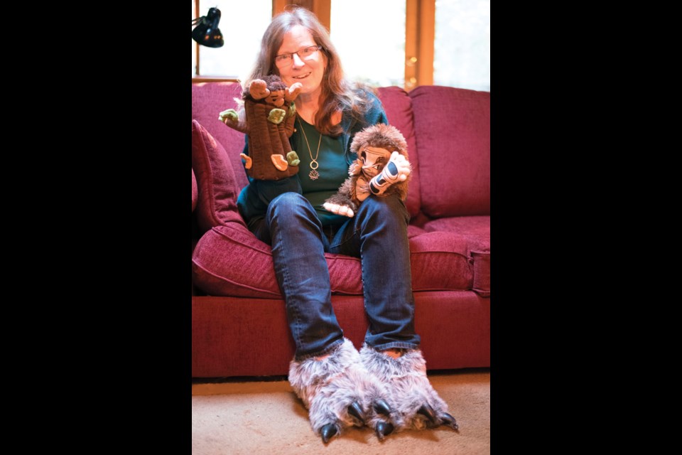 Author Heather Conn puts on some of the sasquatch-related gear she’ll feature at her Dec. 7 book launch.