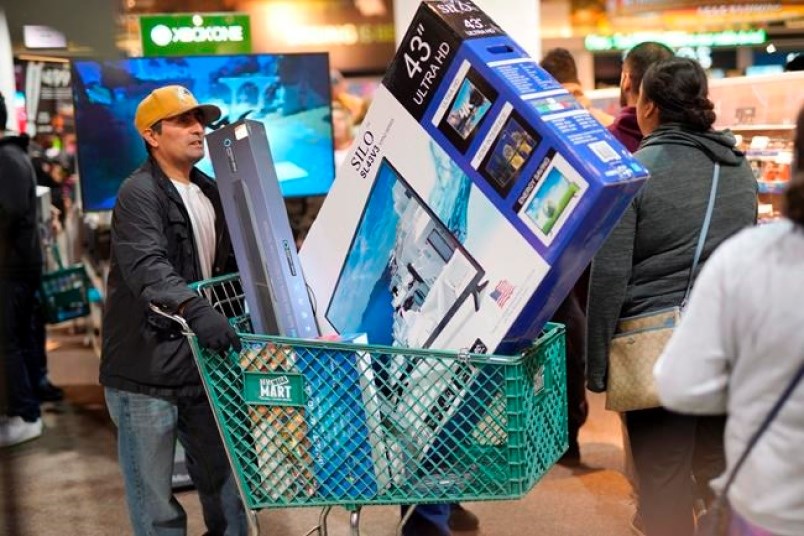 Black Friday shoppers wait in line to check out at the Nebraska Furniture Mart store in Omaha, Neb., Friday, Nov. 23, 2018. Canadian shoppers craving a deal increasingly turn to Black Friday — a sales bonanza imported from America, where retailers long slashed prices the day after their Thanksgiving holiday — at the expense of another sales spree, Boxing Day.