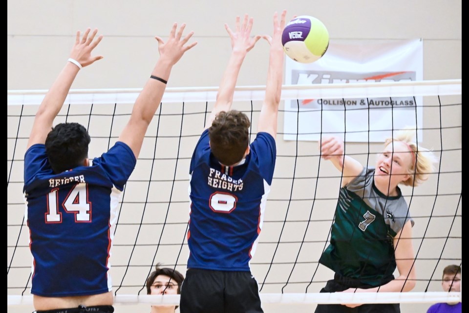 Delta Pacers Mikah Oldham powers the ball past a pair of Fraser Heights blockers during Thursday's action at the BC AAA Boys Volleyball Championships at the Langley Events Centre. Delta fell 3-2 to the Surrey school.