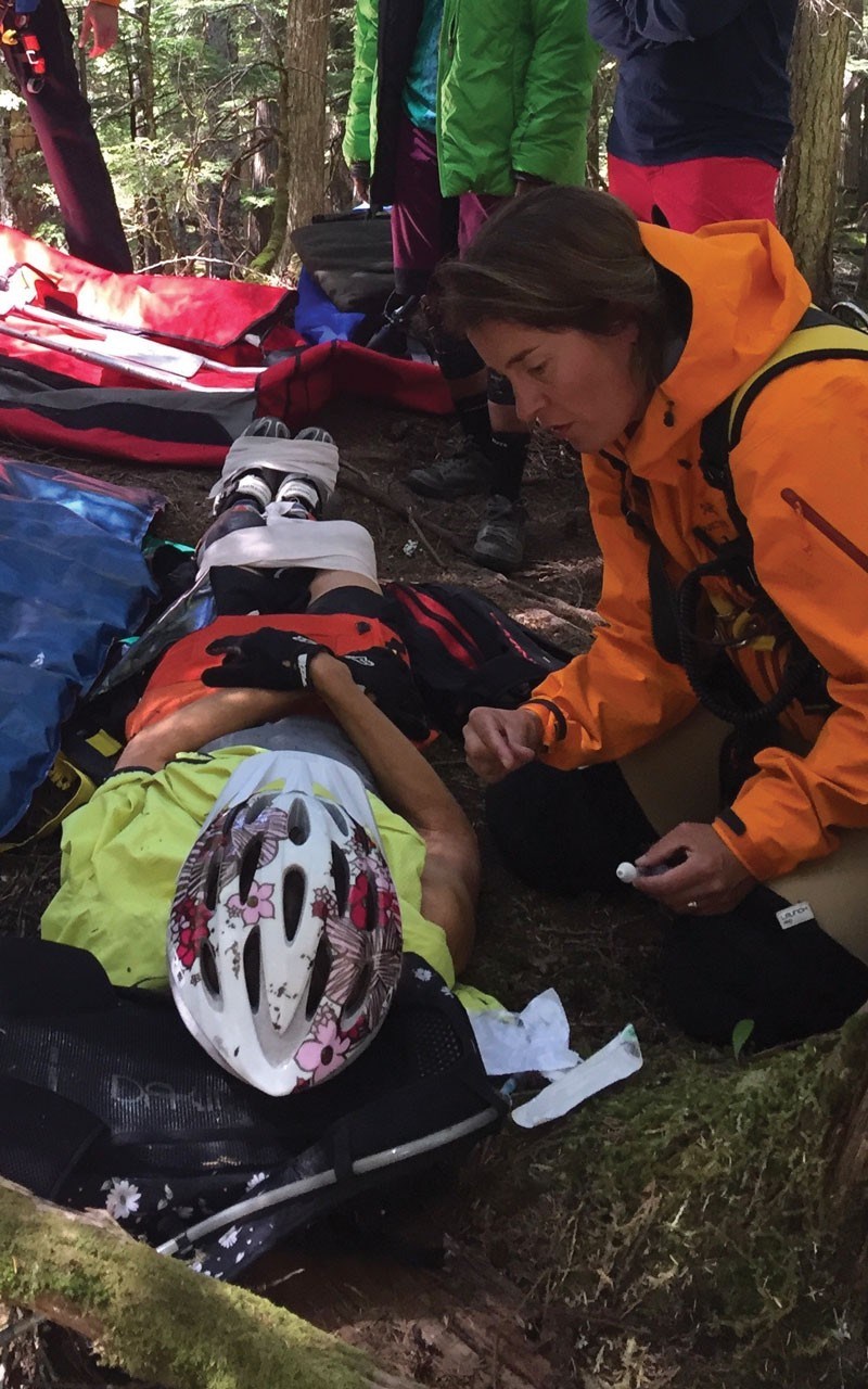 Dr. Renata Lewis-Arnott helps an injured mountain biker. Photo submitted