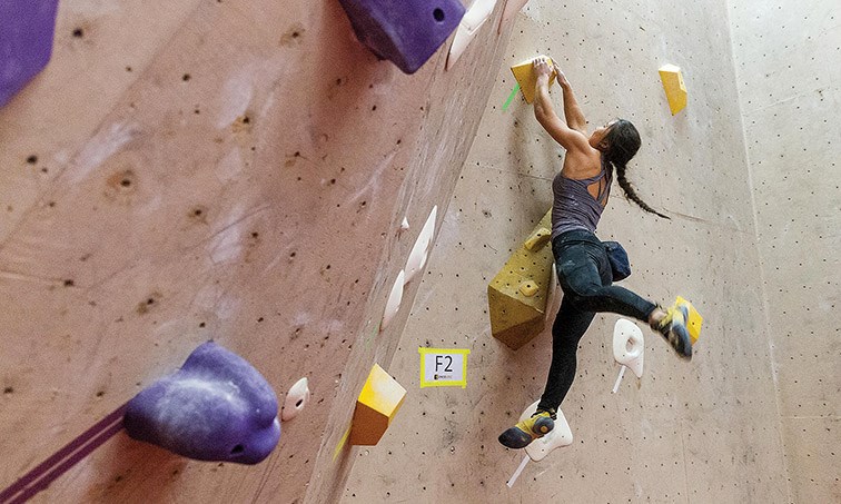 Citizen Photo by James Doyle. Natasha Jang makes her way up the second of three routes at OVERhang Climbing Gym on Saturday evening in the women's final of the Crush Fest Bouldering Competition.