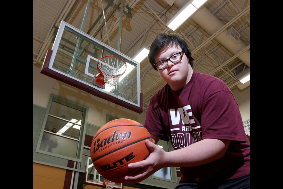 MARIO BARTEL/THE TRI-CITY NEWS Grade 12 student Reid Demelo went from being the team manager of the Heritage Woods Kodiaks senior boys basketball team to an international Internet and media celebrity after he hit a three-point shot at the buzzer in the team's opening game of its own Kodiak Klassic tournament last Thursday.