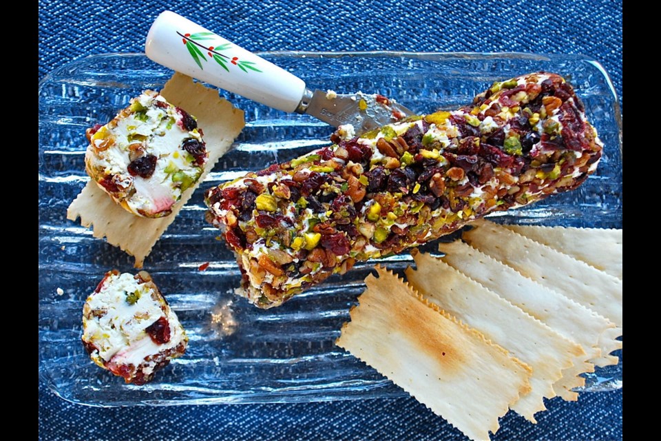 This festive-looking cheese log is flavoured and coated with nuts, cranberries and orange.