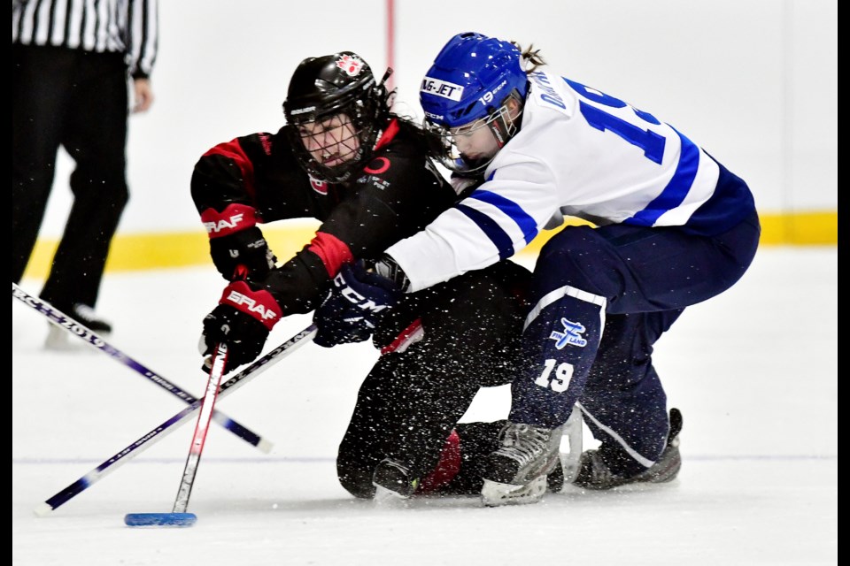 Canada's Shaundra Bruvall fights to maintain possession under pressure from Finland's Camilla Ojapalo during Saturday's Sam Jacks world ringette championship in Burnaby. Finland racked up its seventh straight world title, beating Canada 5-1.