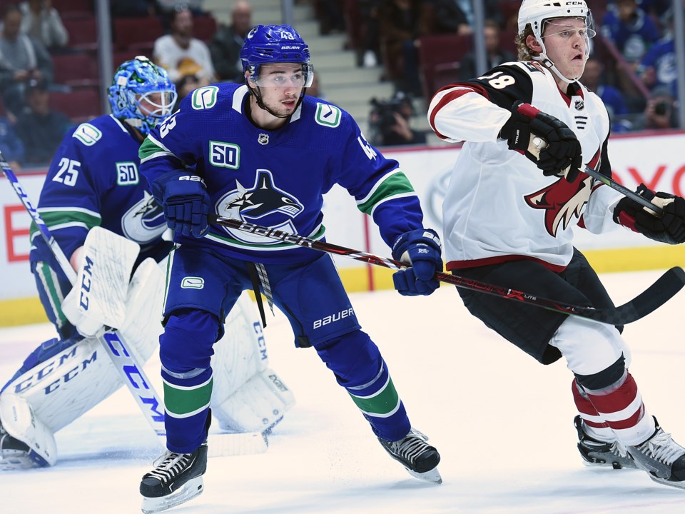 Quinn Hughes defends the front of the net during the Canucks 2019 preseason.