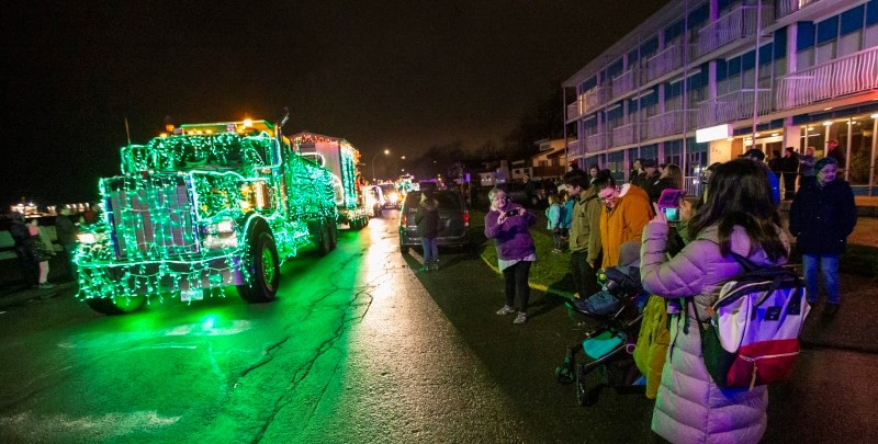 A crowd lines Dallas Road on Saturday night to watch the start of the annual lighted trucks parade. Dec. 7, 2019.