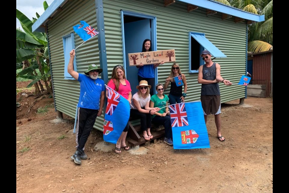 Catriona Day (left two) and other volunteer welcomed the Fijian family to the new home. Photo submitted