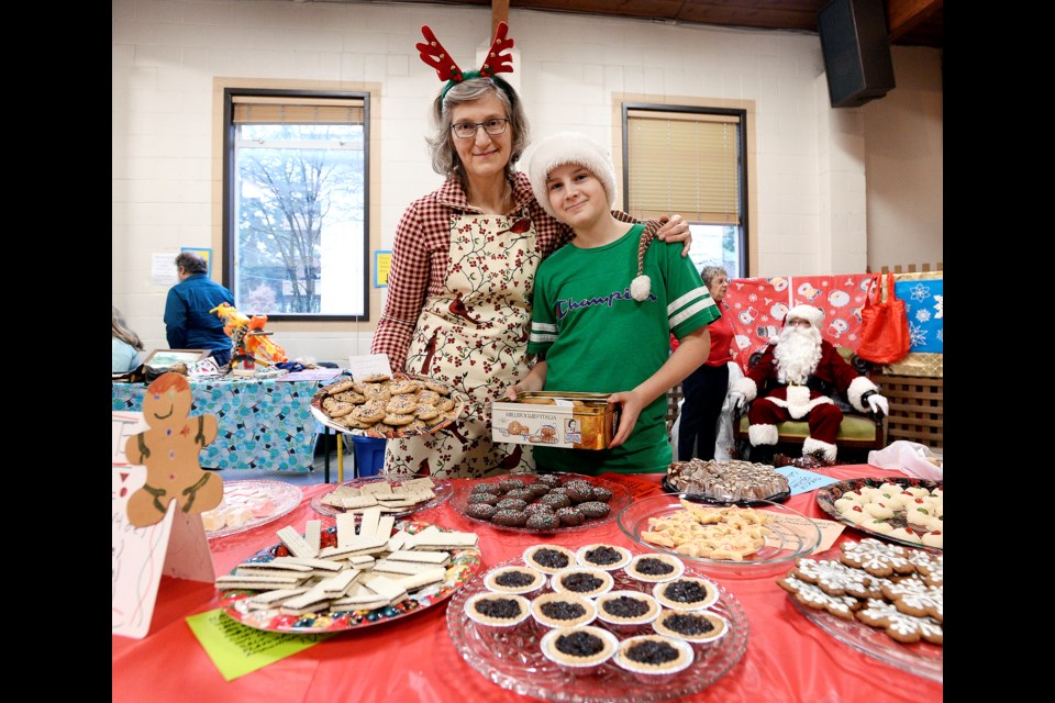 Antonia and Sasha Reynolds, 12, helped out at the Knox Presbyterian Church’s cookie sale on Saturday.