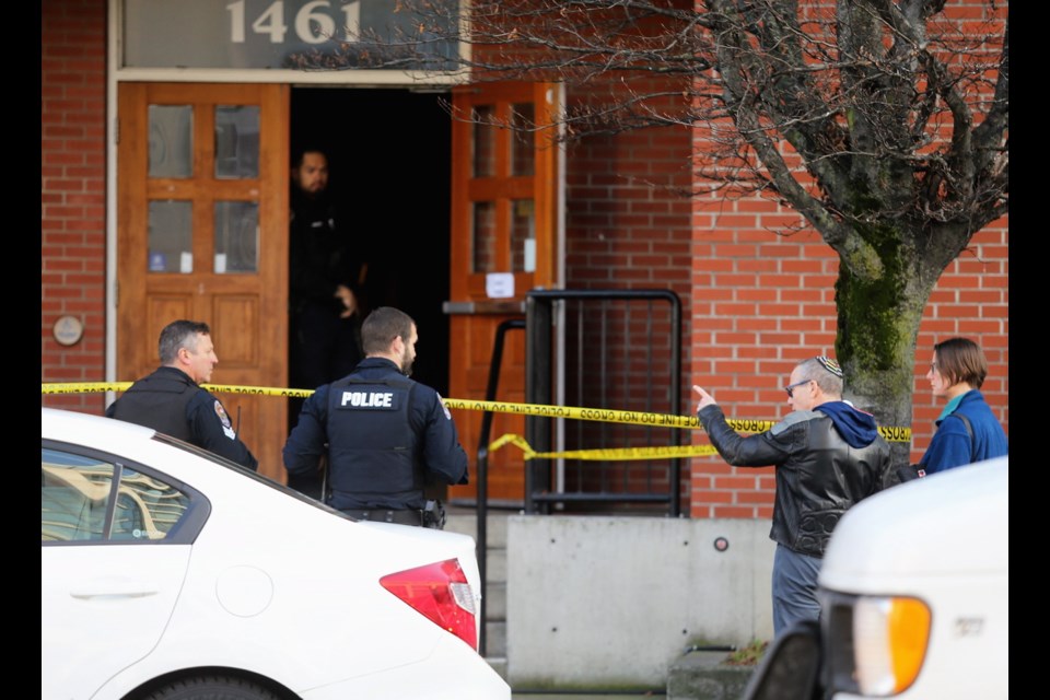 Rabbi Harry Brechner, second from right, talks to officers, as Saanich and Victoria Police respond to a standoff at the Congregation Emanu-El on Monday.