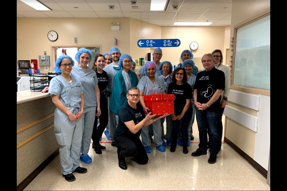 Coun. Chuck Puchmayr, in front - holding the box, was among the folks from Operation Popcorn who visited Burnaby Hospital on Dec. 6.