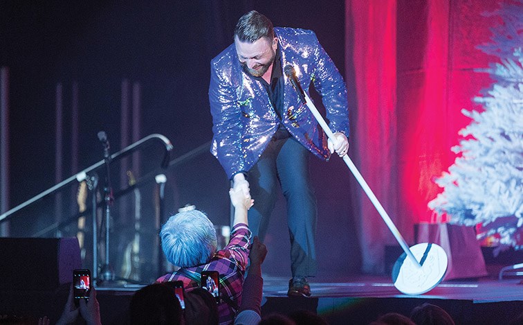 Citizen Photo by James Doyle. A lucky fan shakes hands with Johnny Reid while he performs on stage at CN Centre on Wednesday night during the Prince George stop of the My Kind of Christmas tour.