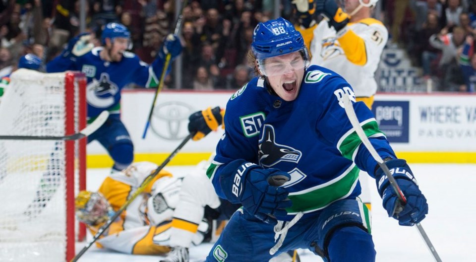 Adam Gaudette celebrates a goal with the Vancouver Canucks.