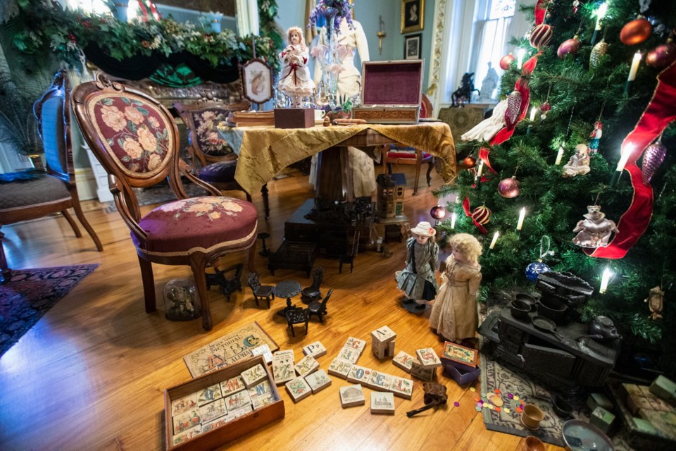 Classic Christmas toys such as toy blocks, dolls and wooden board games are found under the Christmas tree in Craigdarroch Castle's drawing room.