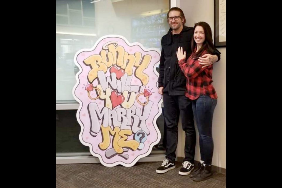 Bunny Blacklear with her fianc&eacute; Scotty Minch. Minch proposed on Thursday holding up a large sign to one of the highway cameras she monitors on the Lions Gate Bridge for her job.