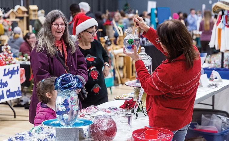 Citizen Photo by James Doyle. A vendor demonstrates their product at Prince George Civic Centre on Sunday during the Winterfest Christmas Craft Market.