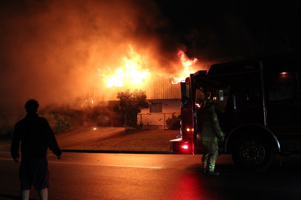 Flames leap from the windows of a two-storey house in Capitol Hill early Tuesday morning.