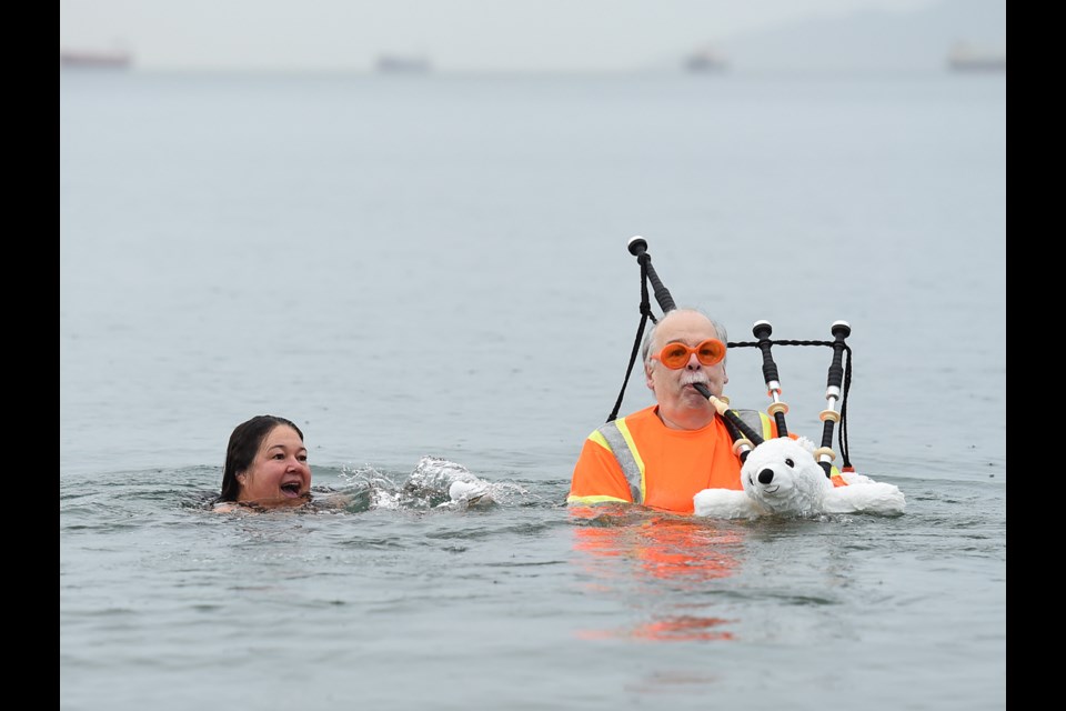 Lisa Pantages and swim regular George Pajari take a quick dip in English Bay Dec. 17 ahead of the 100th Polar Bear Swim Jan. 1. Photo Dan Toulgoet