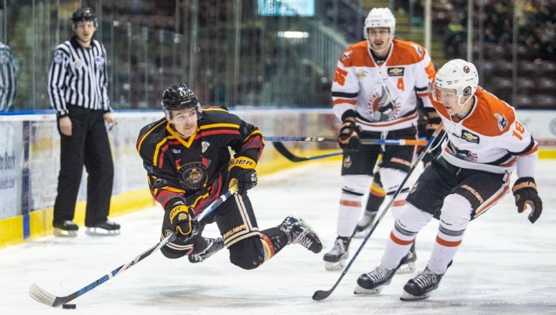 The Nanaimo Clippers' -- and Burnaby Winter Club alum -- Kyler Kovich, far right, looks to check a Victoria opponent in B.C. Hockey League action. The forward will join former BWC teammate Ryan Helliwell at the Canadian Junior A Hockey League's prospect game in January.