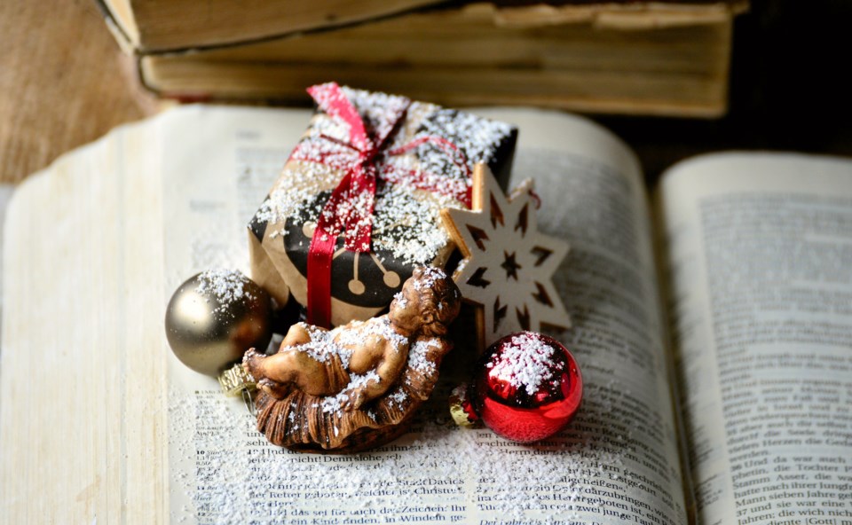 Christmas story-themed ornaments on a book.