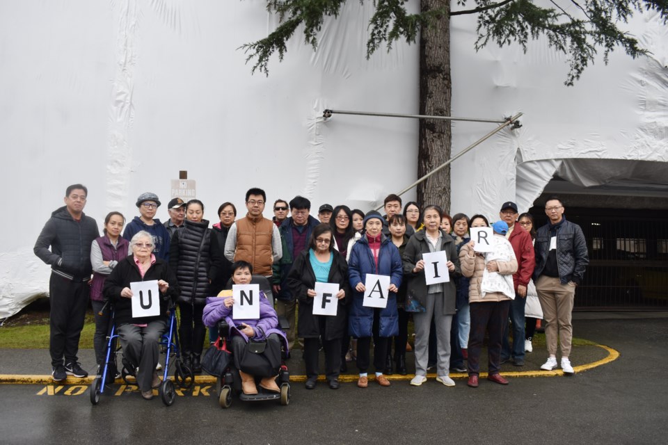Dozens of residents gathered in front of their building last week. Nono Shen photo