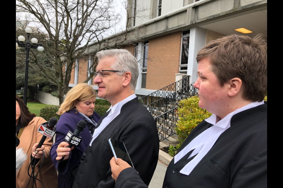 Prosecutors Patrick Weir and Clare Jennings outside the Victoria Courthouse Thursday.