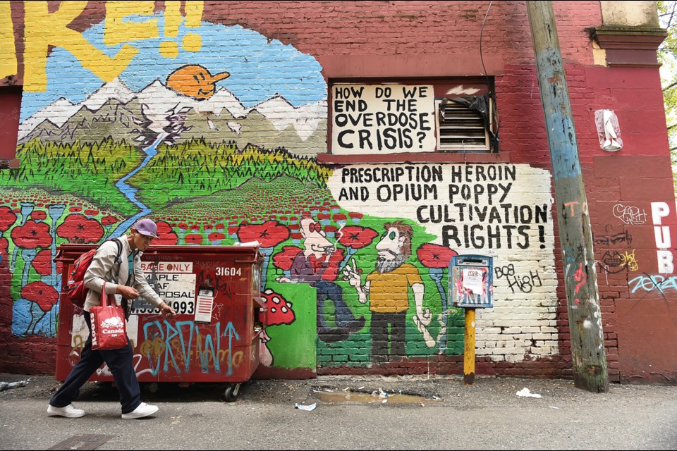 Mural artists bring colour to Vancouver’s Downtown Eastside. Bob High's murals often carry a political message. Photo Dan Toulgoet