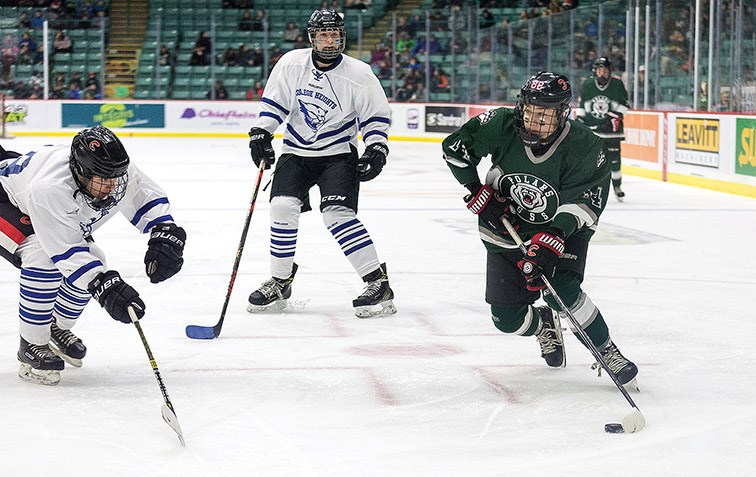 PGSS Polars forward Decker Mujcin puts a shot on goal against the College Heights Cougars on Friday afternoon at CN Centre during the 17th Annual Spirit Hockey Game.