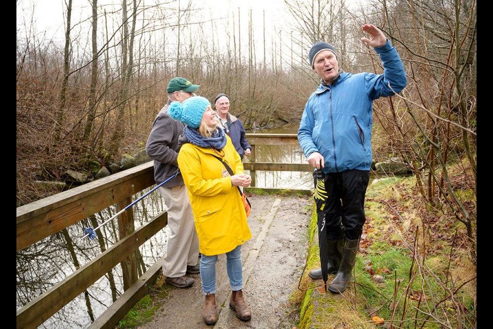 Retired DFO recovery biologist Matt Foy leads a walk through the Mashiter salmon spawning channels as part of the Squamish River Watershed Society's International Year of the Salmon grand finale event. Foy was instrumental in the construction of the channels in 1987. The Squamish River Watershed Society's Rhonda O'Grady (in yellow) looks on.