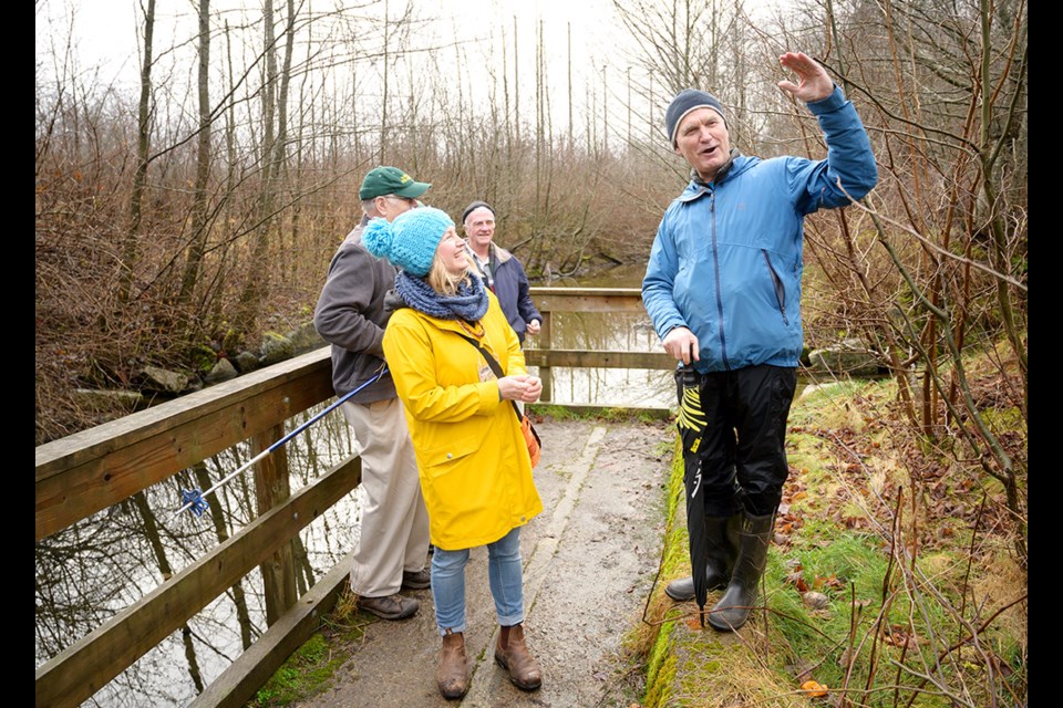 Retired DFO recovery biologist Matt Foy leads a walk through the Mashiter salmon spawning channels as part of the Squamish River Watershed Society's International Year of the Salmon grand finale event. Foy was instrumental in the construction of the channels in 1987. The Squamish River Watershed Society's Rhonda O'Grady (in yellow) looks on.
