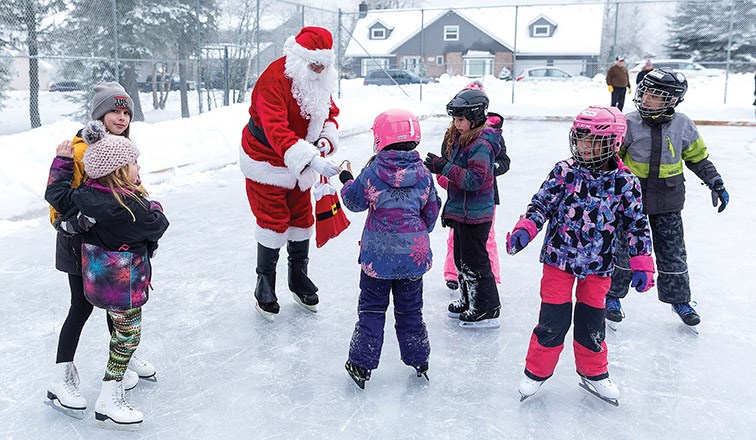 Citizen Photo by James Doyle. Santa hands out candy canes to the kids skating at Ridgeview rink on Sunday afternoon during the Hart Community Association’s 11th Annual Skate with Santa.