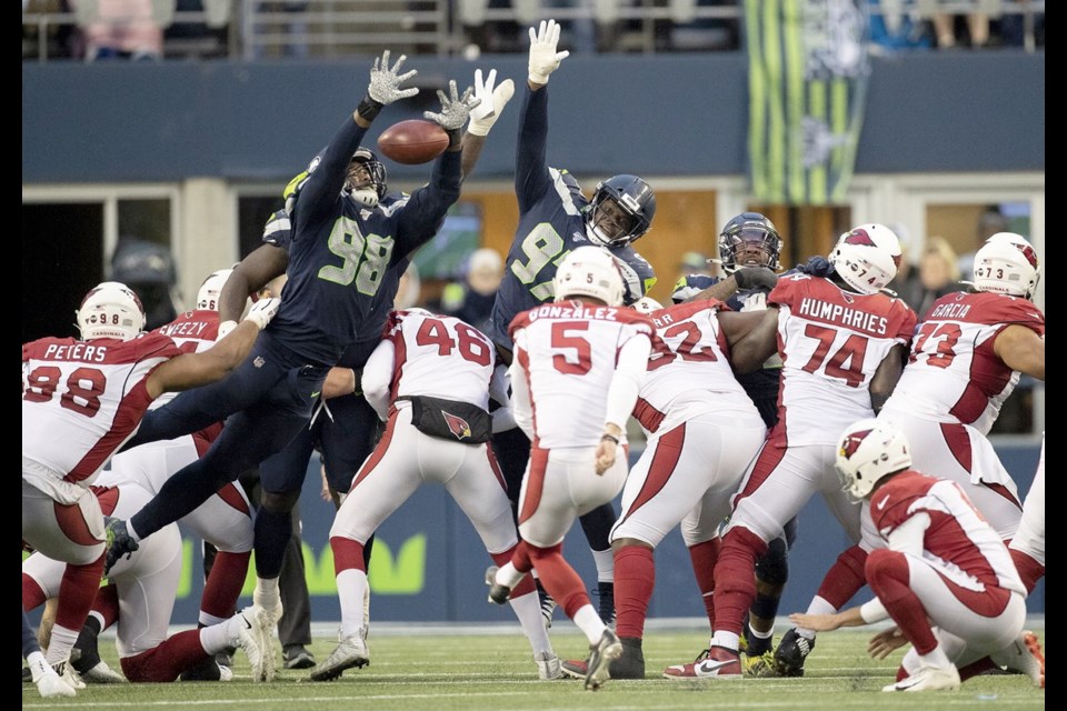 Seattle Seahawks defensive end Rasheem Green (98) and defensive tackle Poona Ford (97) block an Arizona Cardinals field goal attempt in the third quarter on Sunday at CenturyLink Field in Seattle.
