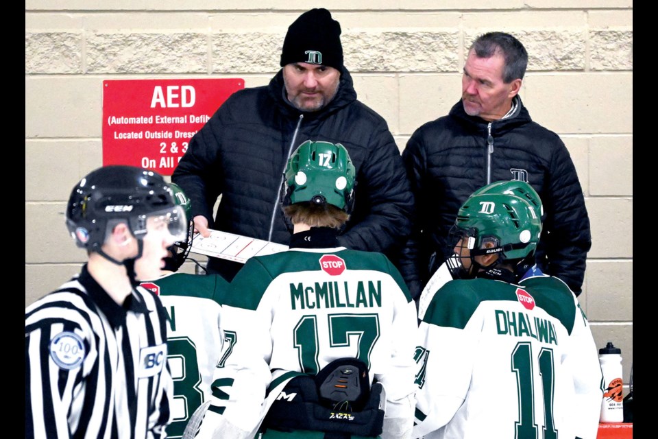 Delta Hockey Academy Bantam Prep Green head coach Milan Dragicevic (left) and assistant Harry Dion talk to their players during regular season action against St. Georges.