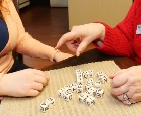 A teen chats with a senior; generic photo