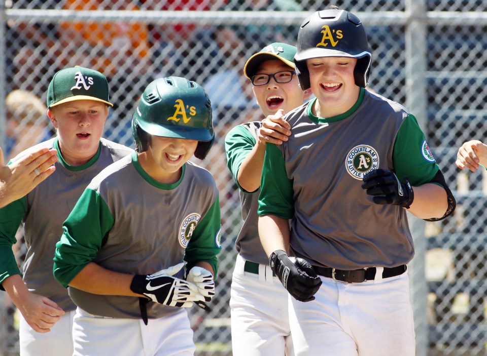 Coquitlam's Matthew Shanley, right, celebrates his seventh homerun with his teammates at the BC Litt