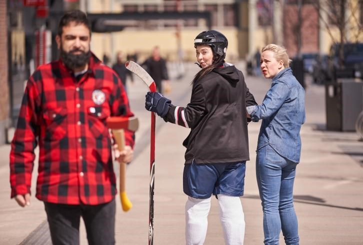 “Hockey player checks out lumberjack while woman in Canadian tuxedo looks on in disbelief” is one of