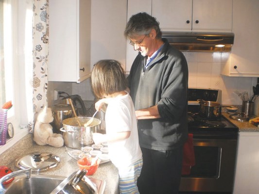 Brian White makes the family's traditional recipe for Christmas cupcakes with the help of his daughter, under the careful supervision of her teddy bear.