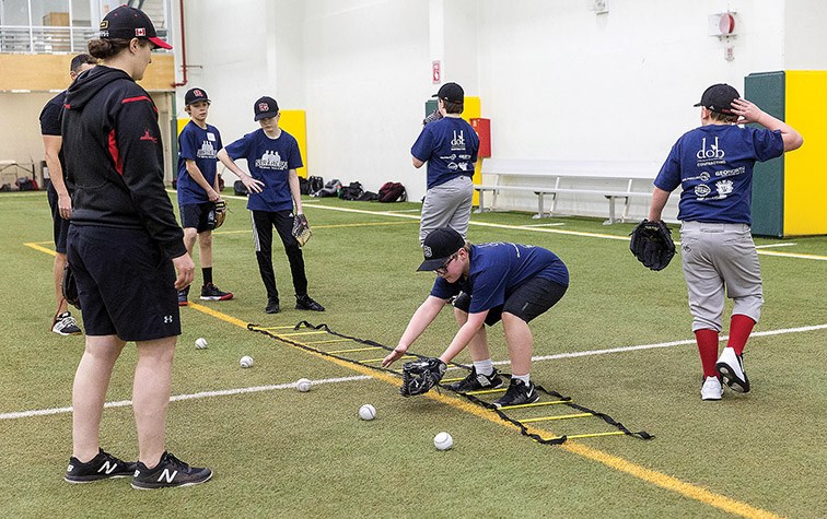 Citizen Photo by James Doyle. Amanda Asay looks on as players do a footwork drill on Saturday afternoon at Northern Sport Centre during day two of Northern Baseball Training’s 3rd Annual Winter Baseball Camp.