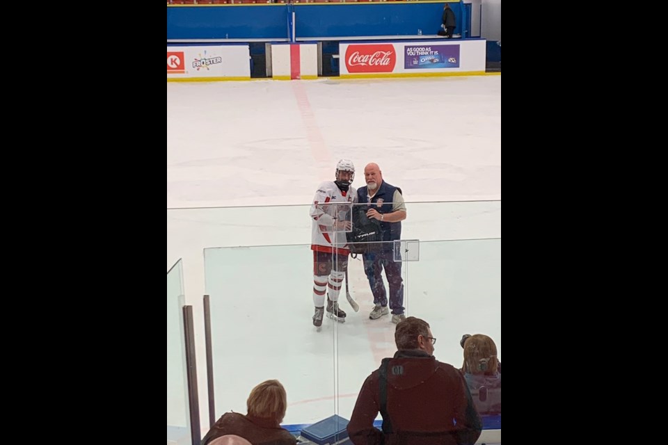 Cariboo Cougars forward Brennan Bott receives his game MVP award Tuesday afternoon in Calgary after he scored two goals and had one assist in a 4-3 quarterfinal win over the Okanagan Rockets.