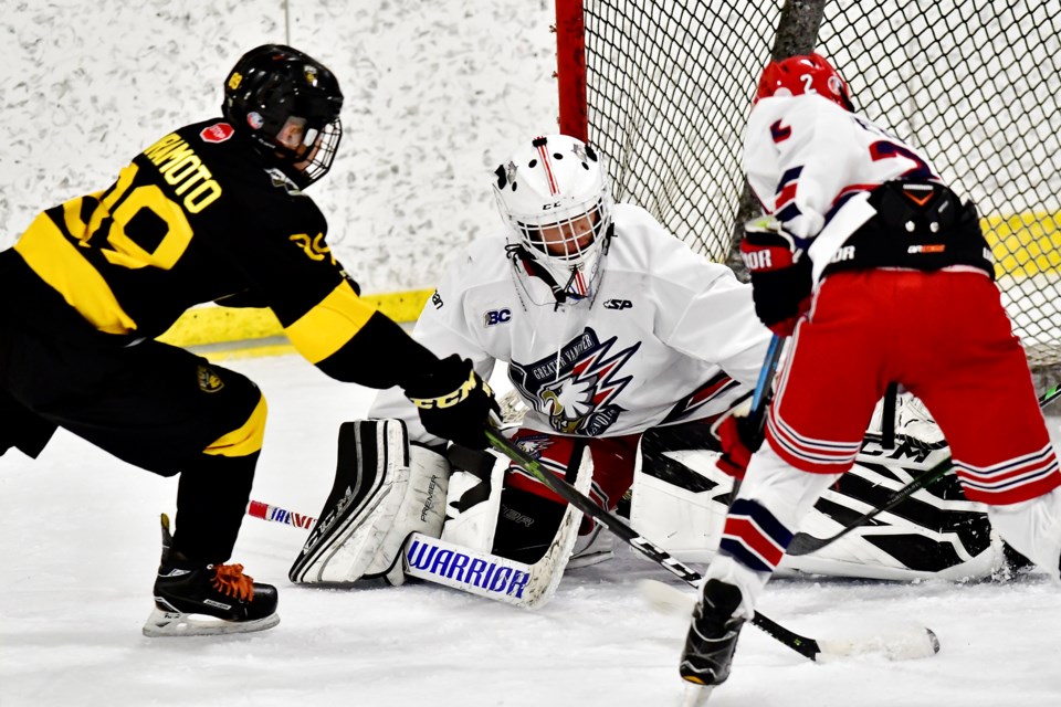 The Burnaby Winter Club prep AAA bantam Bruins' Dryden Kuramoto tests Greater Vancouver Canadians netminder Remy Quintoro during the team's first game of the Pat Quinn Classic at Bill Copeland Arena on Saturday. The Bruins would build momentum after the opening game 4-4 draw and knock off the Cariboo Cougars 11-3 in the gold medal final.