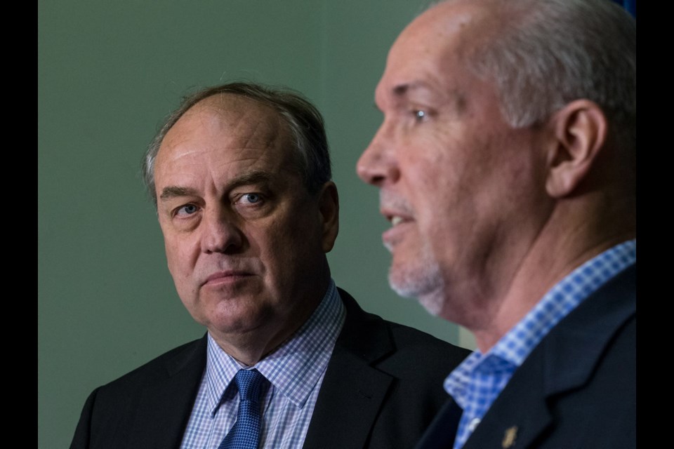 B.C. Green Party Leader Andrew Weaver, left, and B.C. NDP Leader John Horgan hold a press conference at the legislature on Wednesday, June 14, 2017.