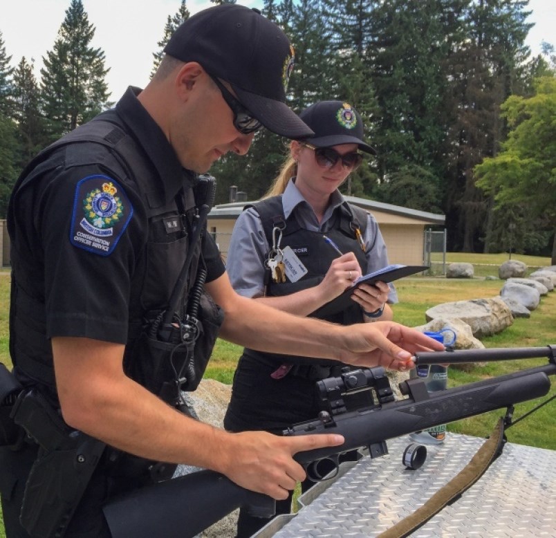 Conservation officer Wyatt Pile and Mackenzie Mercer, who is a wildlife safety officer, work at Mund