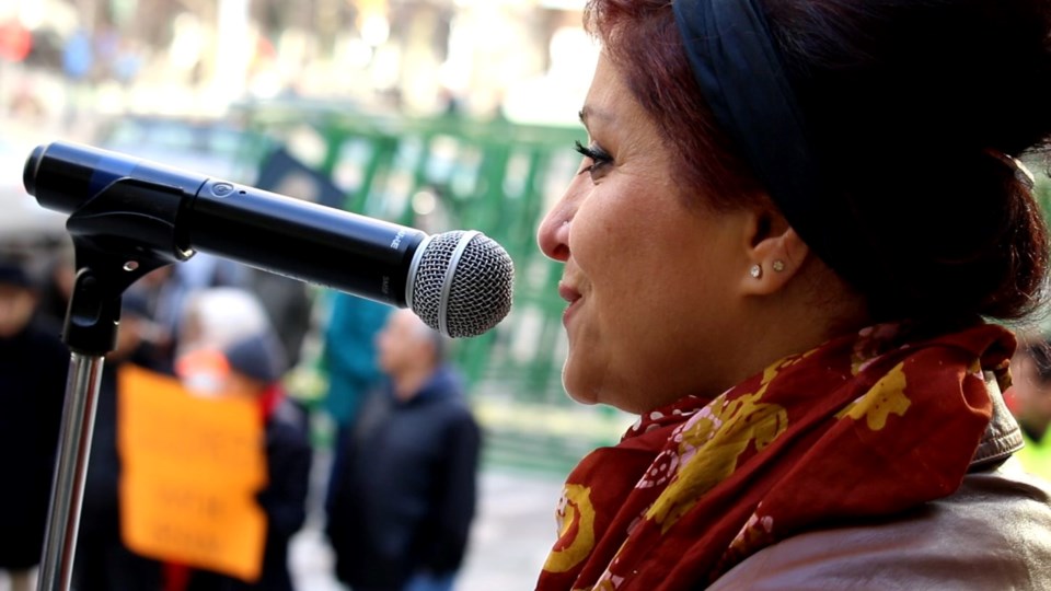 Mahbubeh (Maya) Mojtahed emcees at a rally in Vancouver in support of protestors attacked in a viole